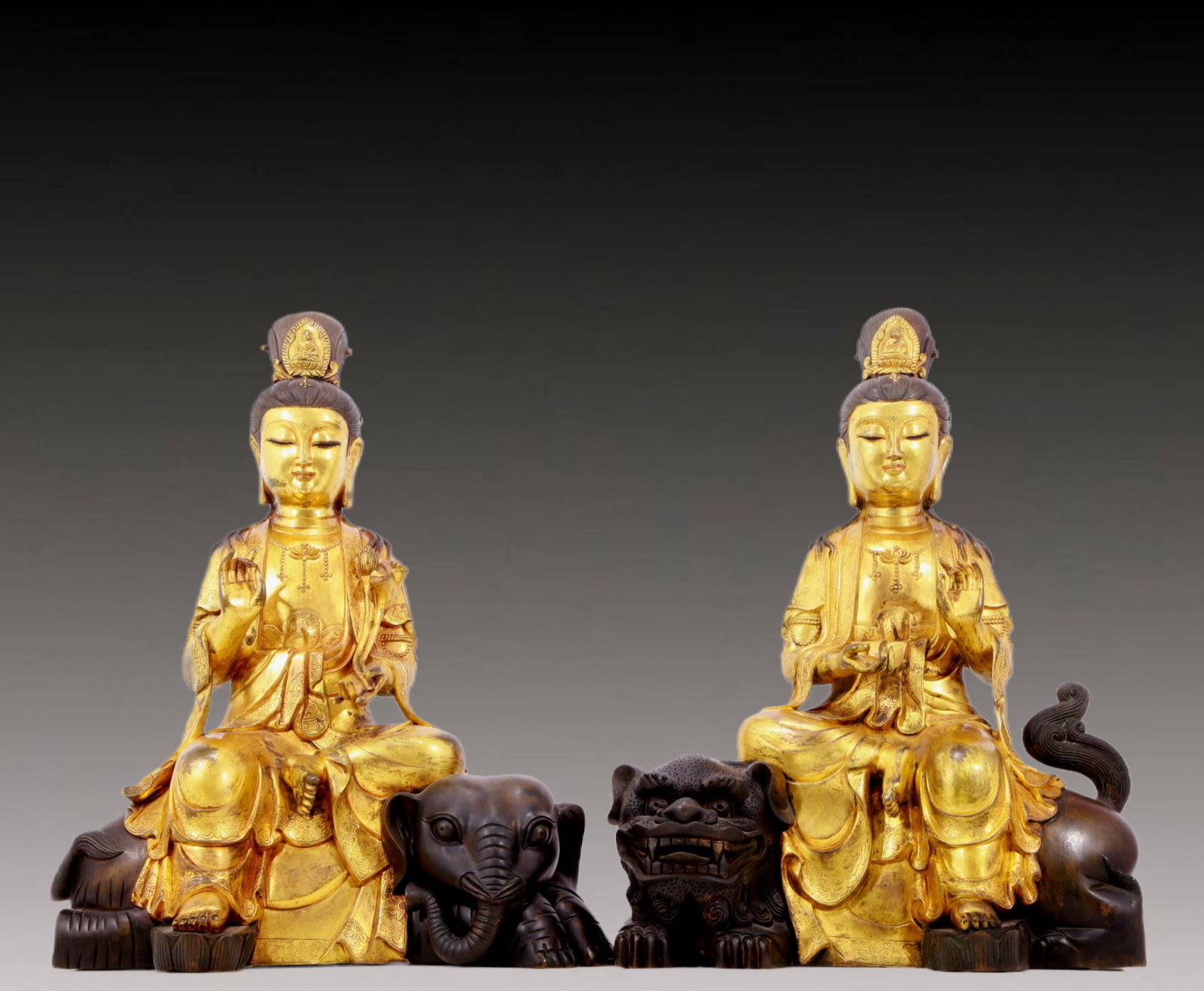 A solemn gilt bronze statues of Manjushri and Samantabhadra: A Gilt bronze statues of Manjushri and Samantabhadra, from the Qing Dynasty in China. The Bodhisattva has a graceful and peaceful posture. His face is solemn and kind, and his eyes are deep, as if he 