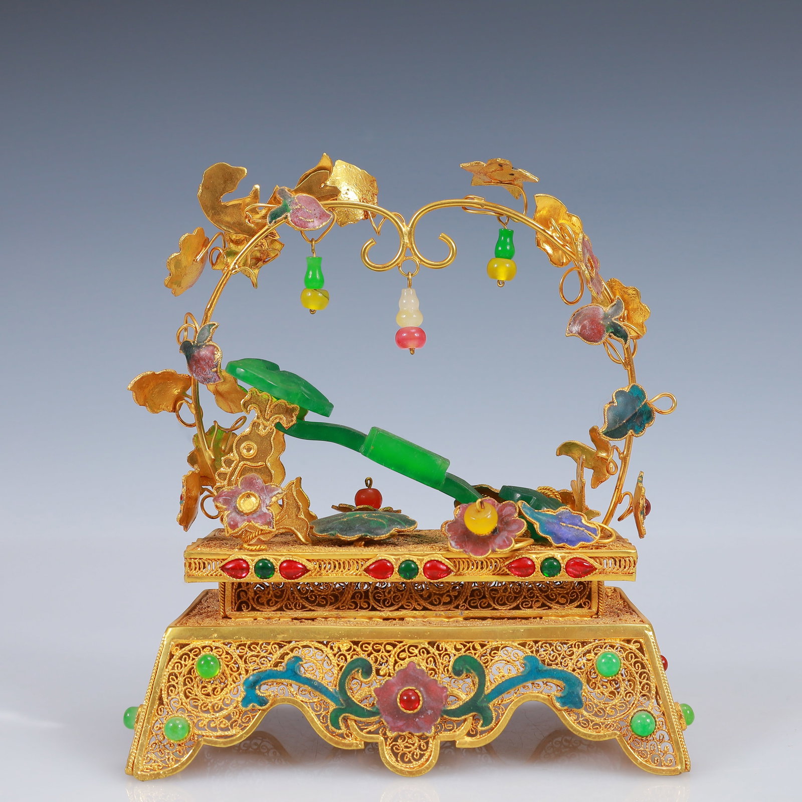 An Exquisite Filigree and Gilding Inlaid Jadeite Ruyi Ornament,Inlaid Gems: An Exquisite Filigree and Gilding Inlaid Jadeite Ruyi Ornament,Inlaid Gems,Qing Dynasty, China,Qianlong Four-Character Mark,Size:5.5inx3.1inx6.7in,Weight:452g 花丝鎏金嵌&