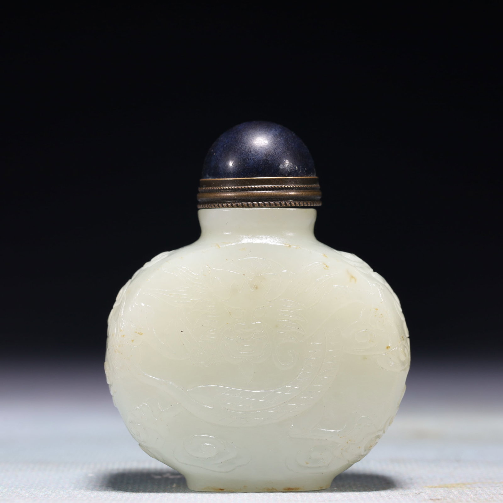 An Exquisite White Jade Auspicious Cloud and Dragon Pattern Snuff Bottle: An Exquisite White Jade Auspicious Cloud and Dragon Pattern Snuff Bottle,Qing Dynasty,China,Size:2inx1inx2.5in,Weight:140.9g
