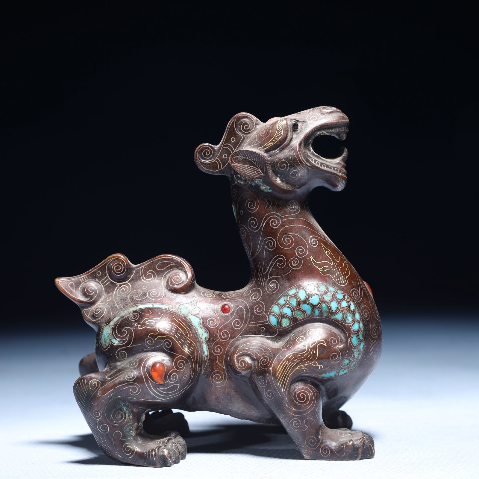 An Exquisite Inlaid Gold and Silver Auspicious Beast Ornament,Inlaid Turquoise: An Exquisite Inlaid Gold and Silver Auspicious Beast Ornament,Inlaid Turquoise,Qing Dynasty,China,Size:4.3inx2.4inx5.1in,Weight:700g 错金银瑞兽摆件,嵌&#