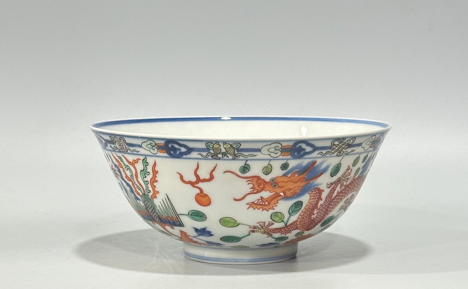 An Exquisite Blue and White Doucai Dragon and Phoenix Pattern Bowl: An Exquisite Blue and White Doucai Dragon and Phoenix Pattern Bowl,Qing Dynasty,China,Kangxi Six-character Mark,Size:2.8inx6.3in 青花斗彩龙凤纹碗,ߑ
