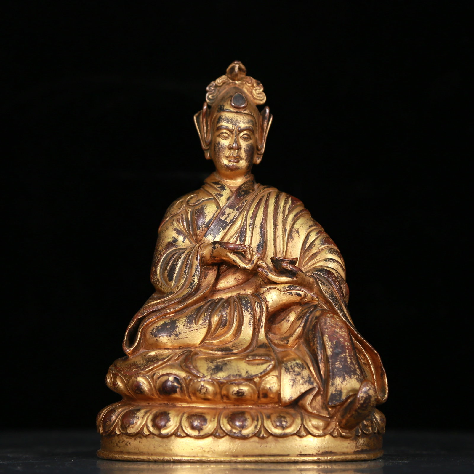 An Excellent Gilt-Bronze Figure Of Mahasiddha: An Excellent Gilt-Bronze Figure Of Mahasiddha. Seated with a dignified expression, body rendered clad in long, flowing robes, the voluminous drapery elegantly cascading in folds. Chinese Qing Dynasty.