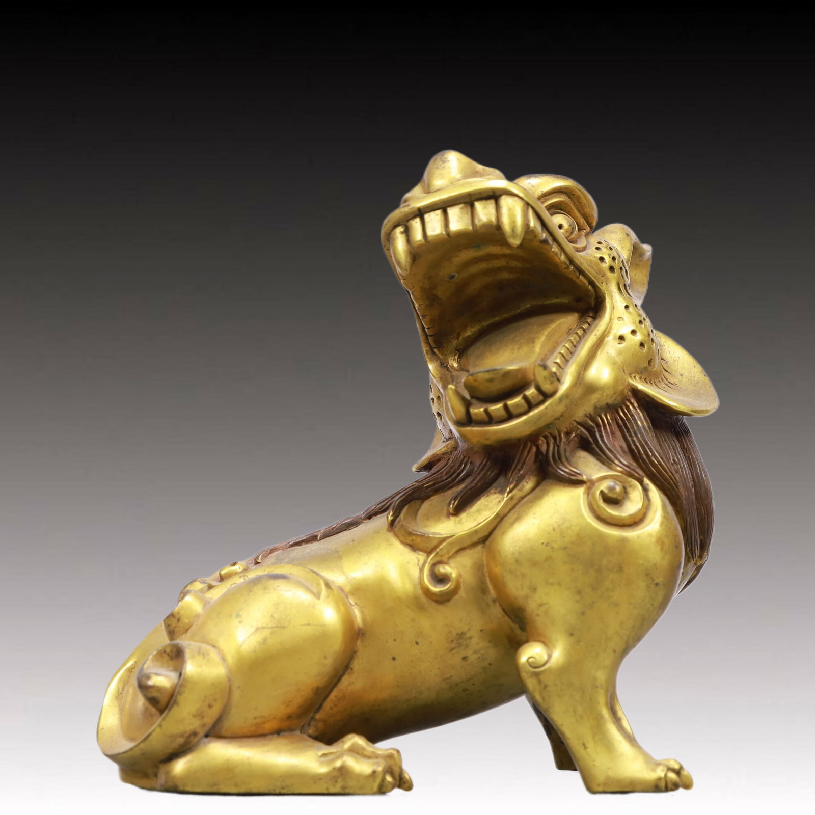 A Solemn Gilt Bronze Lion Ornament: A Solemn Gilt Bronze Lion Ornament,Qing Dynasty, China,Size:7.5inx3.9inx7.3in Weight:3050g 铜鎏金狮摆件,中国清代