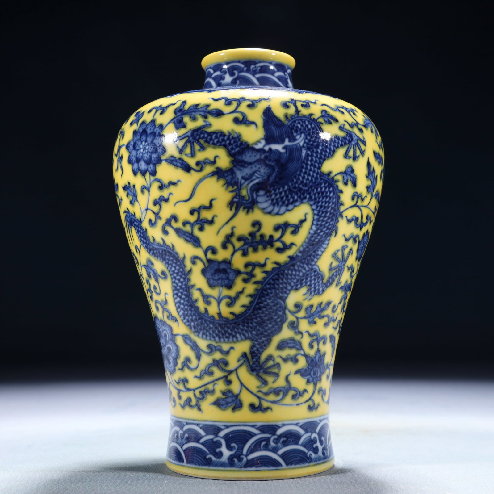An Exquisite Yellow Ground Blue and White Lotus and Dragon Pattern Vase: An Exquisite Yellow Ground Blue and White Lotus and Dragon Pattern Vase,Qing Dynasty,China,Qianlong Six-character Mark,Size:4.7inx7.5in,Weight:1300g 黄地青花缠枝