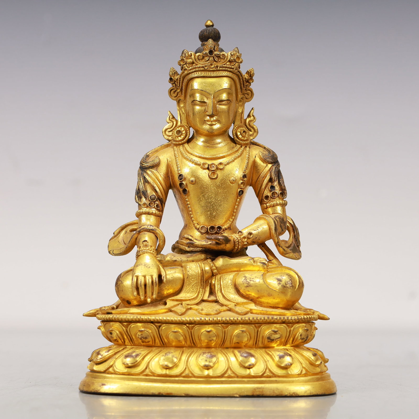 An Excellent Gilt-Bronze Figure Of Longevity Buddha: An Excellent Gilt-Bronze Figure Of Longevity Buddha. Seated on a base with a peaceful expression,body adorned with jewelry ornaments,topknot surmounted by a splendid diadem. Chinese Qing Dynasty. Size