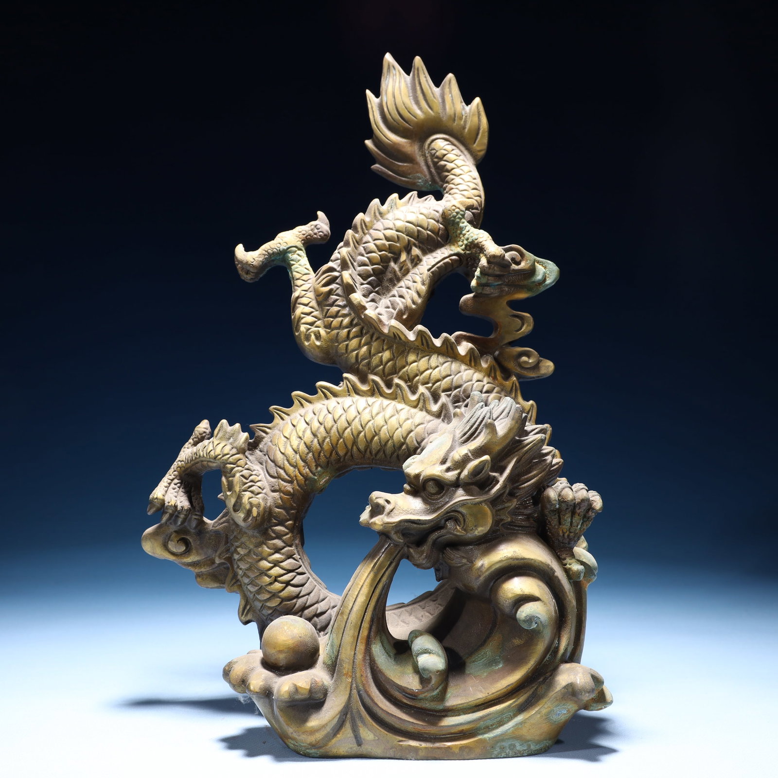 An Exquisite Bronze Auspicious Cloud and Dragon Ornament: An Exquisite Bronze Auspicious Cloud and Dragon Ornament,Ming Dynasty,China,Xuande Four-character Mark,Size:9.1inx4.7inx14.2in,Weight:3900g 铜祥云龙摆件,中