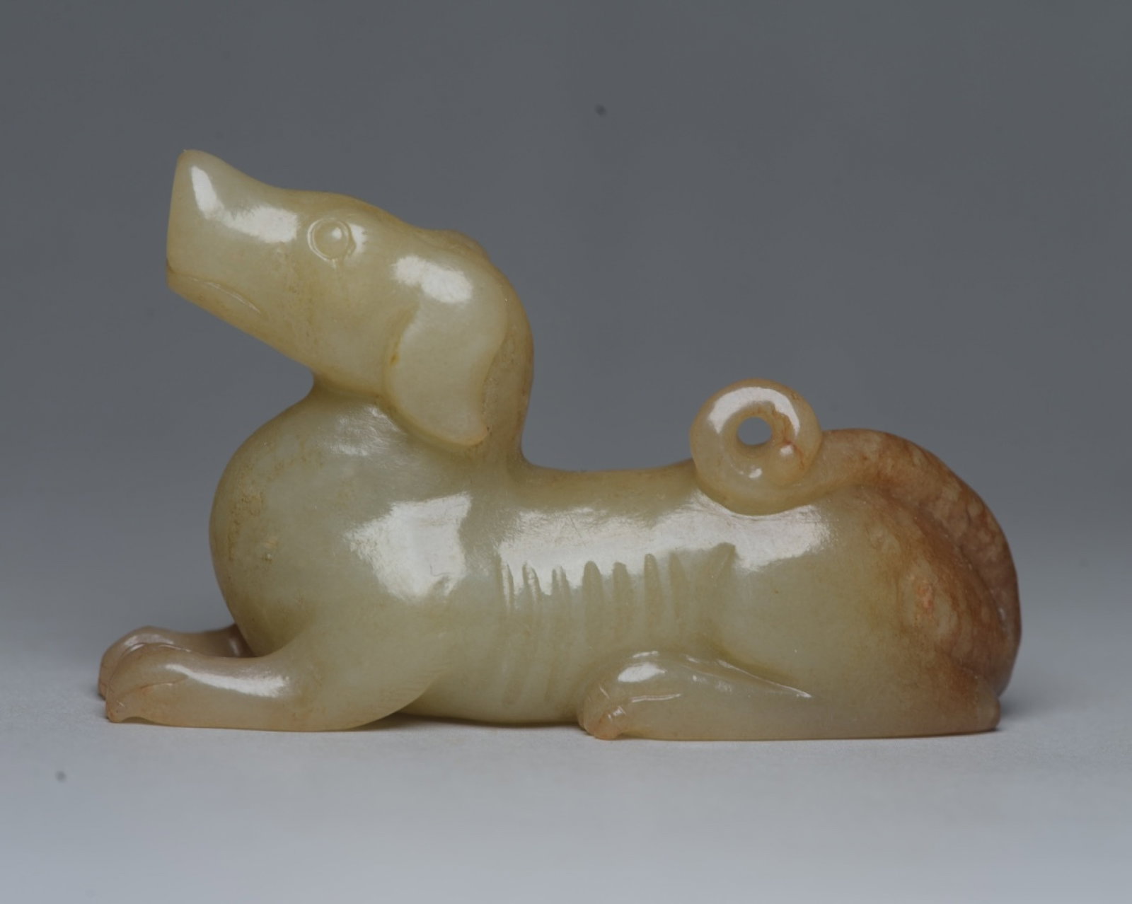 An Exquisite White Jade Dog Ornament: An Exquisite White Jade Dog Ornament,Qing Dynasty,China,Size:2.9inx1.8inx0.8in,Weight:72g 白玉犬摆件,中国清代