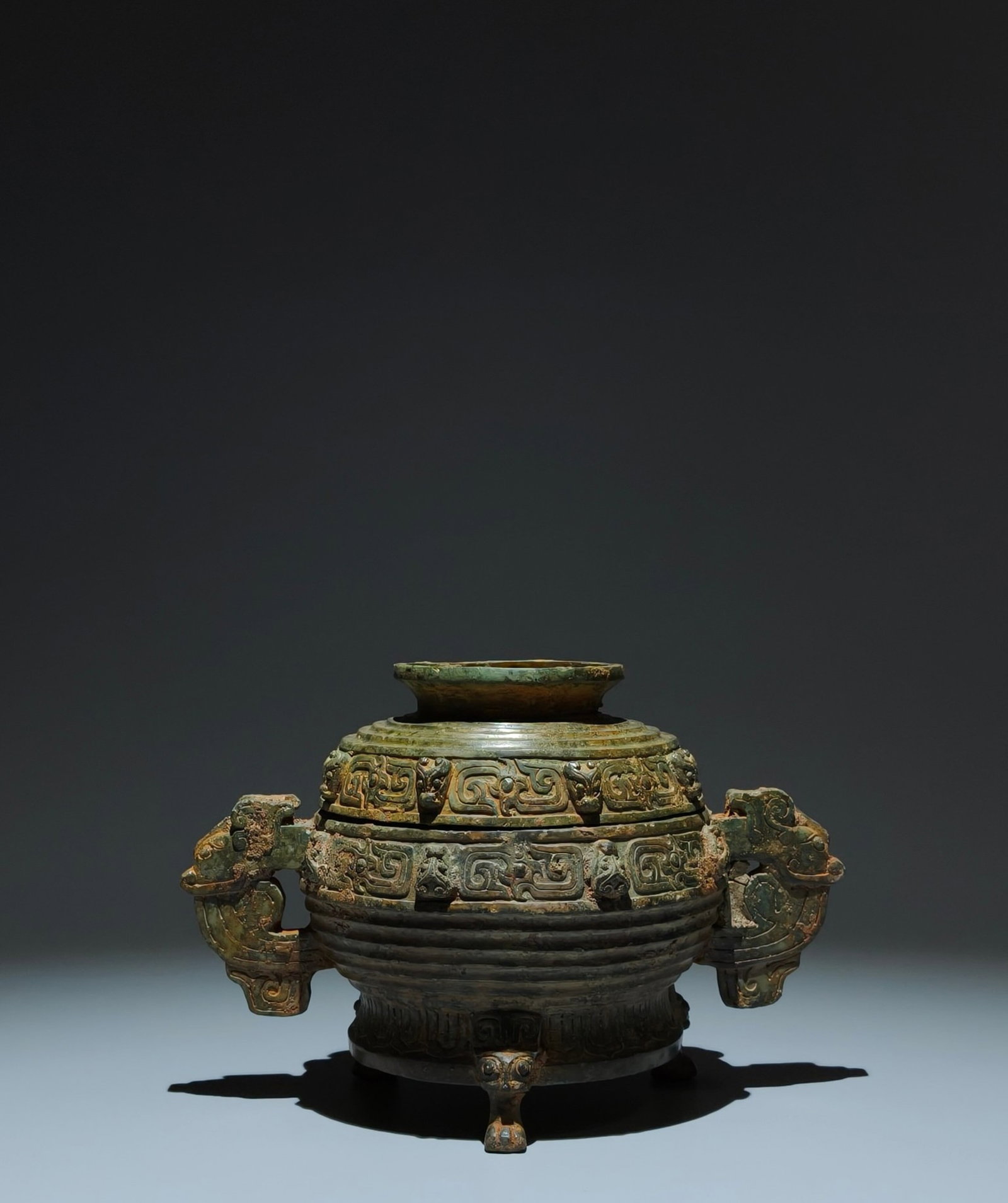 An Archaic Bronze Beast-Ears Tripod Food Vessel,With Inscription: An Archaic Bronze Beast-Ears Tripod Food Vessel,With Inscription,Shang Dynasty,China,Size:6.1inx8.9inx5.5in 青铜兽耳三足食器,带铭文,&#
