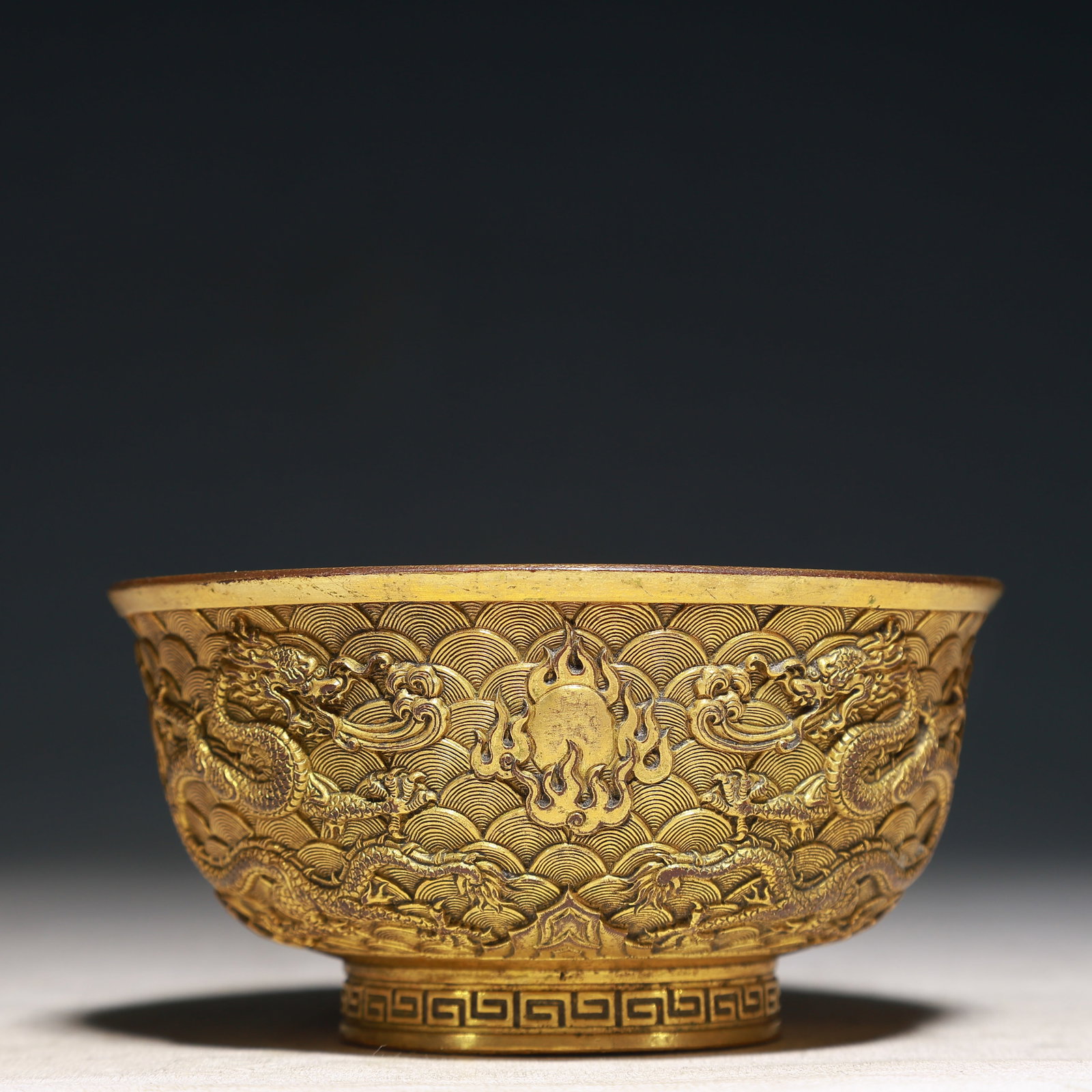 An Exquisite Gilt Bronze Seawater,Auspicious Cloud and Dragon Pattern Bowl: An Exquisite Gilt Bronze Seawater,Auspicious Cloud and Dragon Pattern Bowl,Qing Dynasty,China,Qianlong Four-character Mark,Size:4.7inx2.6in,Weight:500g