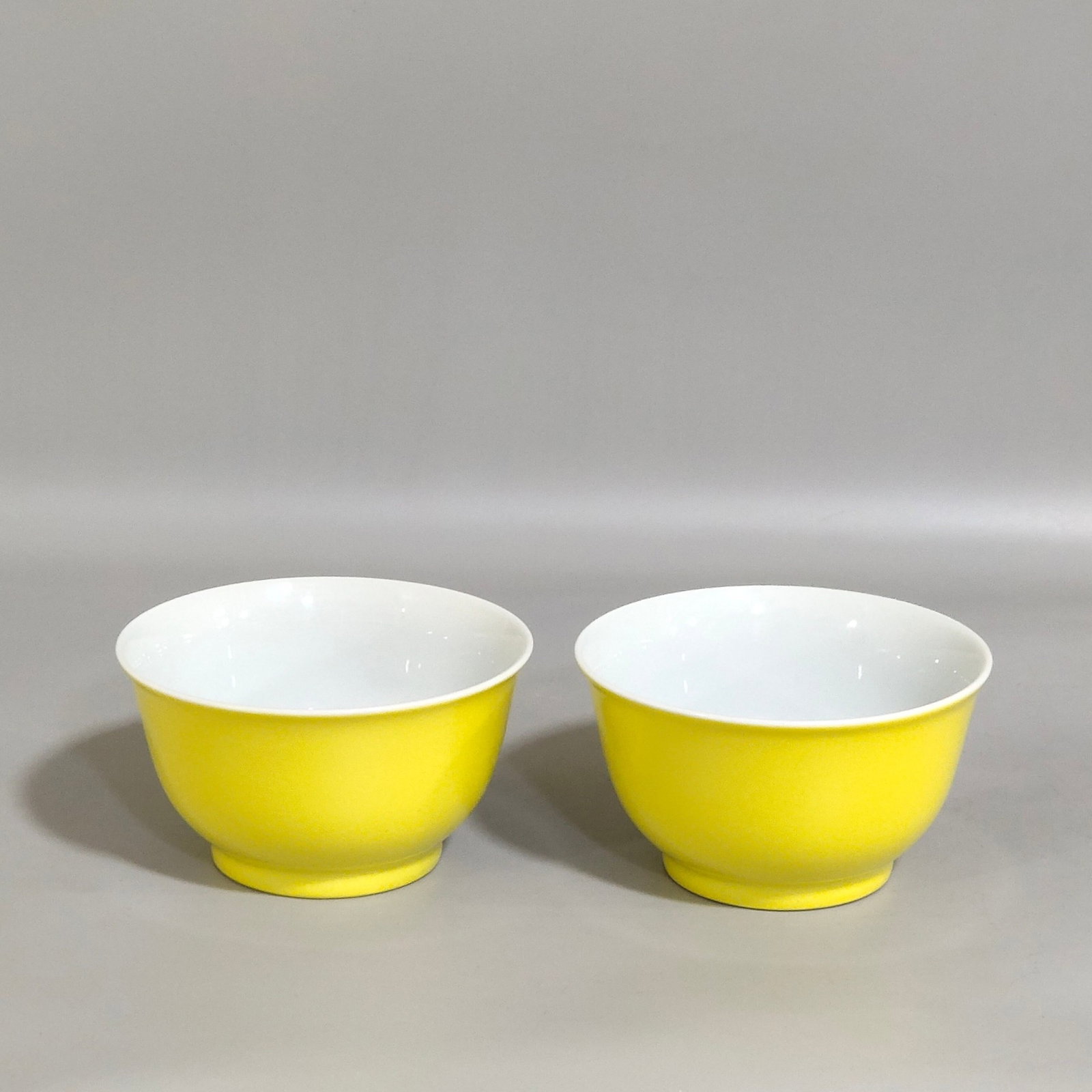 A Pair of Exquisite Yellow Ground Famille-Rose Peach Pattern Cups: A Pair of Exquisite Yellow Ground Famille-Rose Peach Pattern Cups,Qing Dynasty,China,Yongzheng Four-character Mark,Size:1.9inx3.3in 一对黄地粉彩桃纹