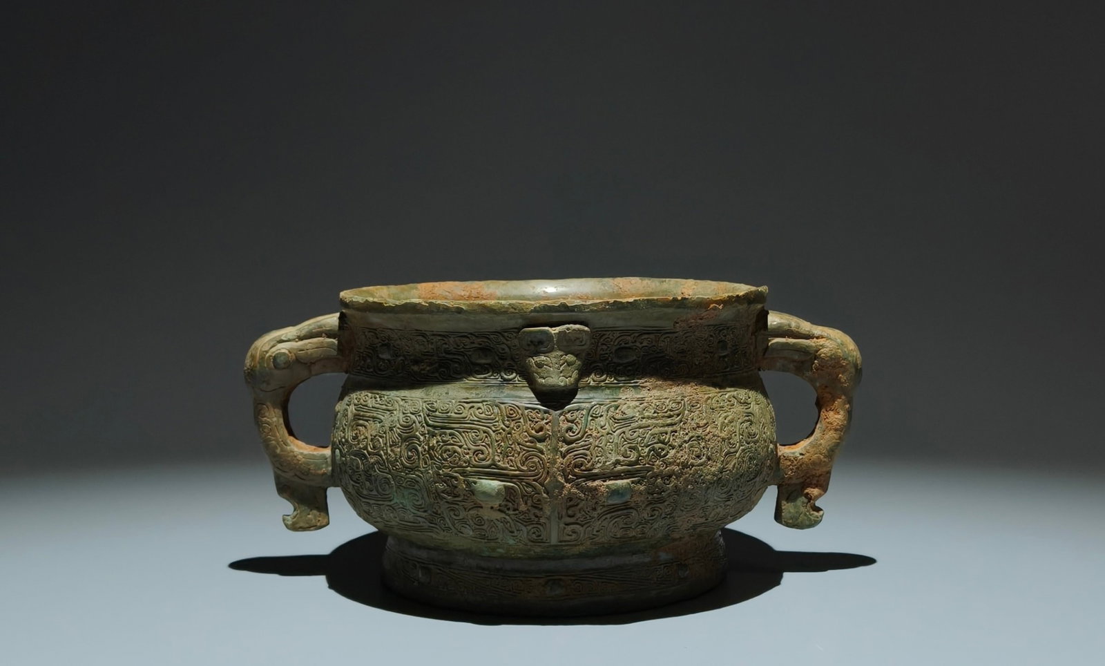 An Archaic Bronze Beast-Face Pattern Double-Ears Food Vessel,With Inscription: An Archaic Bronze Beast-Face Pattern Double-Ears Food Vessel,With Inscription,Shang Dynasty,China,Size:4.3inx9.3inx6.5in 青铜兽面纹双耳食器,४