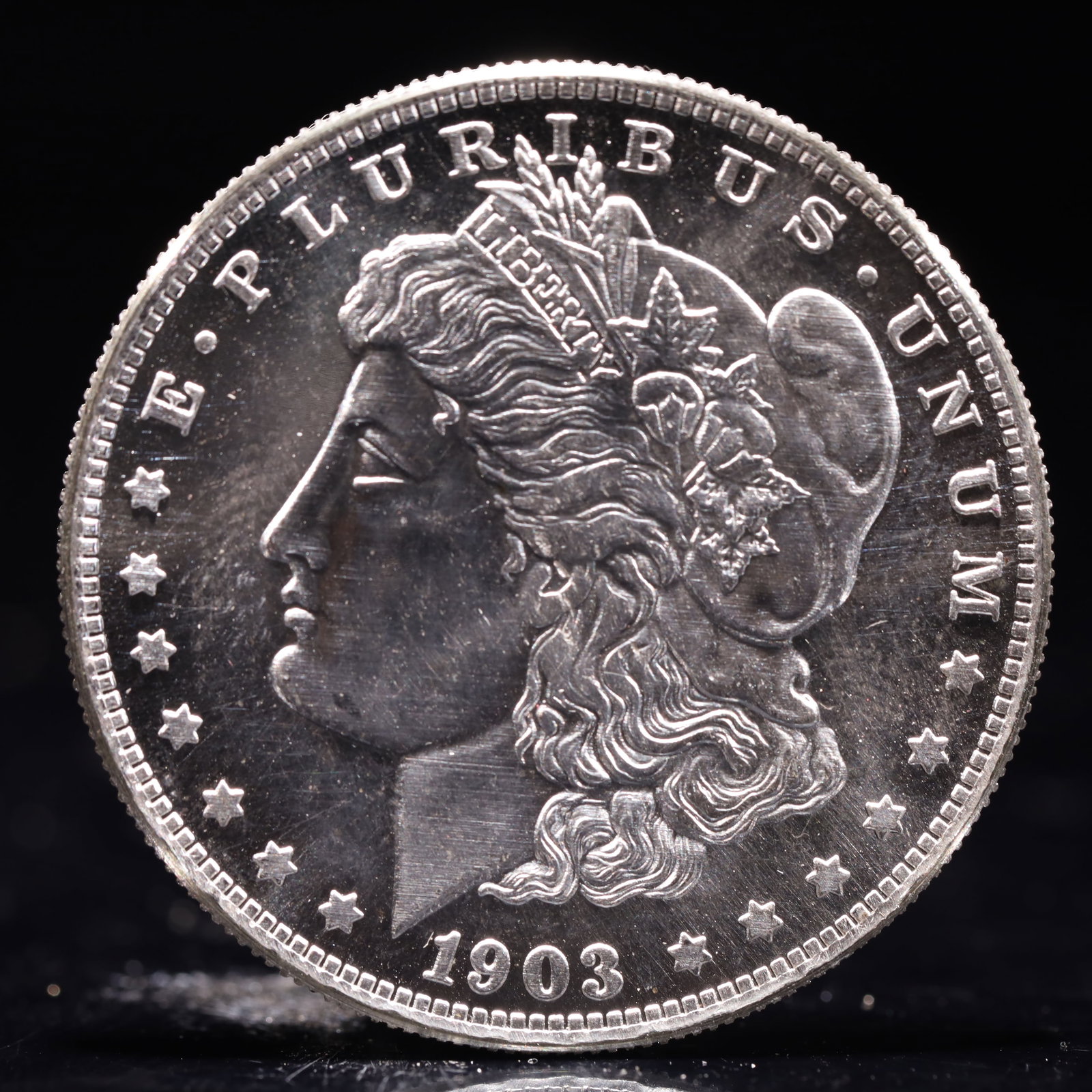 USA Morgan Dollar 1903 Coin: Obv: profile bust with date below and E PLURIBUS UNUM legend and stars around. Rev: eagle with In God we trust above within wreath with UNITED STATES OF AMERICA ONE DOLLAR legend. IN GOD WE TRUST /