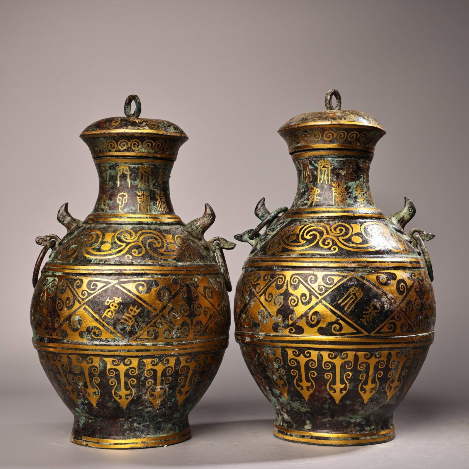 A Pair of Exquisite Bronze Inlaid Gold Beast-Face Pattern Bottles: A Pair of Exquisite Bronze Inlaid Gold Beast-Face Pattern Bottles,the Warring States period in China,Size:10.2inx5.9in,Weight:1600g 一对青铜错金兽面 