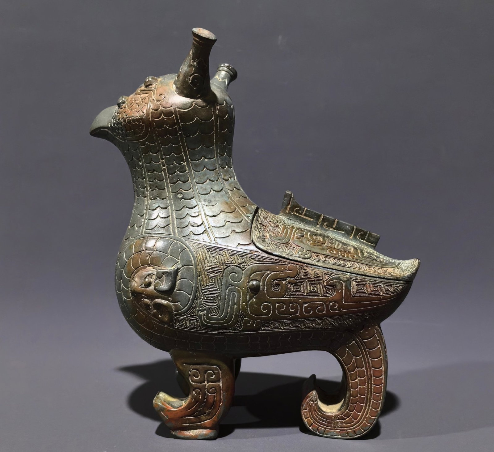 An Archaic Bronze Ancient Owl-Shaped Zun: An Archaic Bronze Ancient Owl-Shaped Zun,Shang and Zhou Dynasty, China,Size:4.5inx7.9inx3.9in,Weight:1.9kg 中国商周.鸮尊