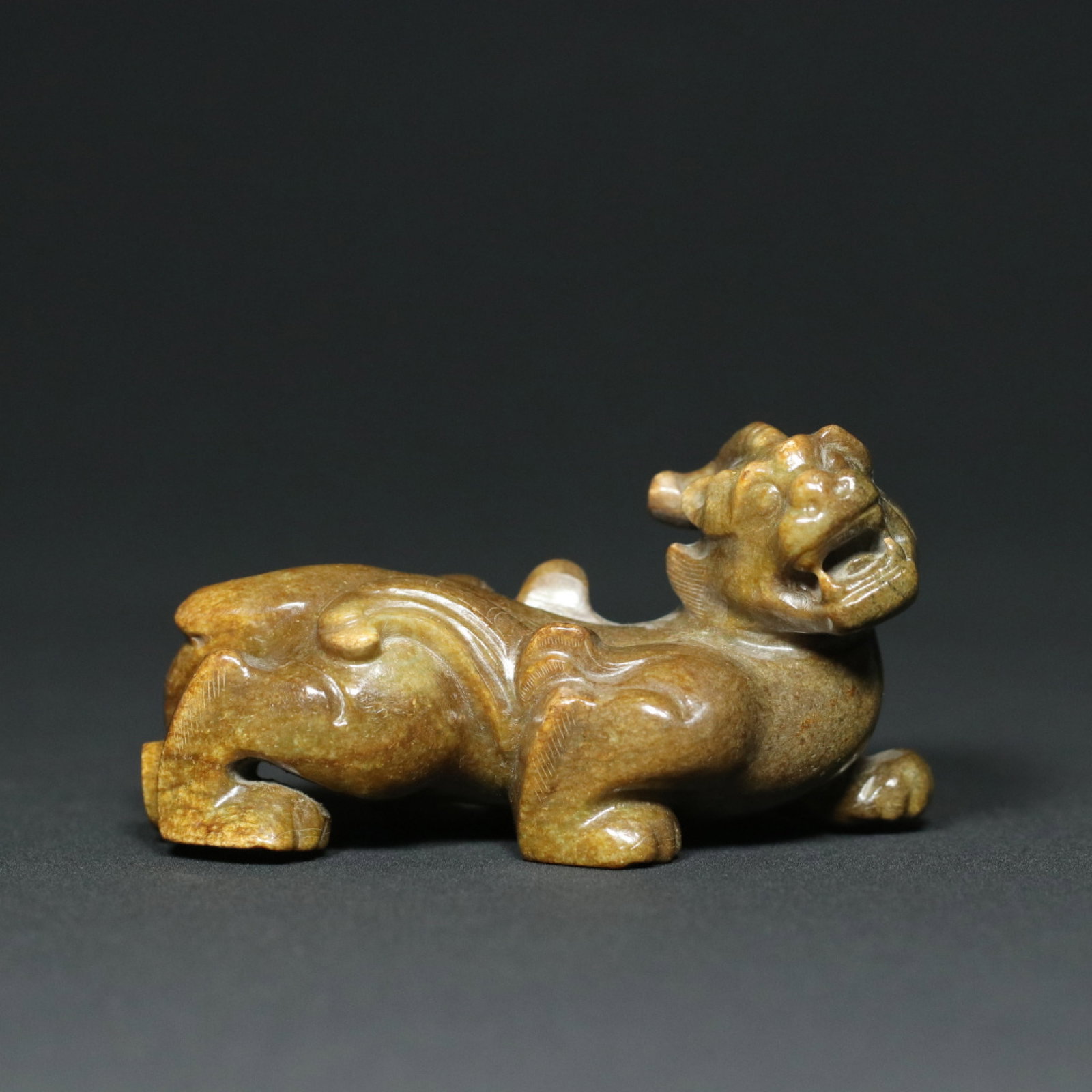 An Exquisite Archaic Jade Auspicious Beast Ornament (1 of 9)
