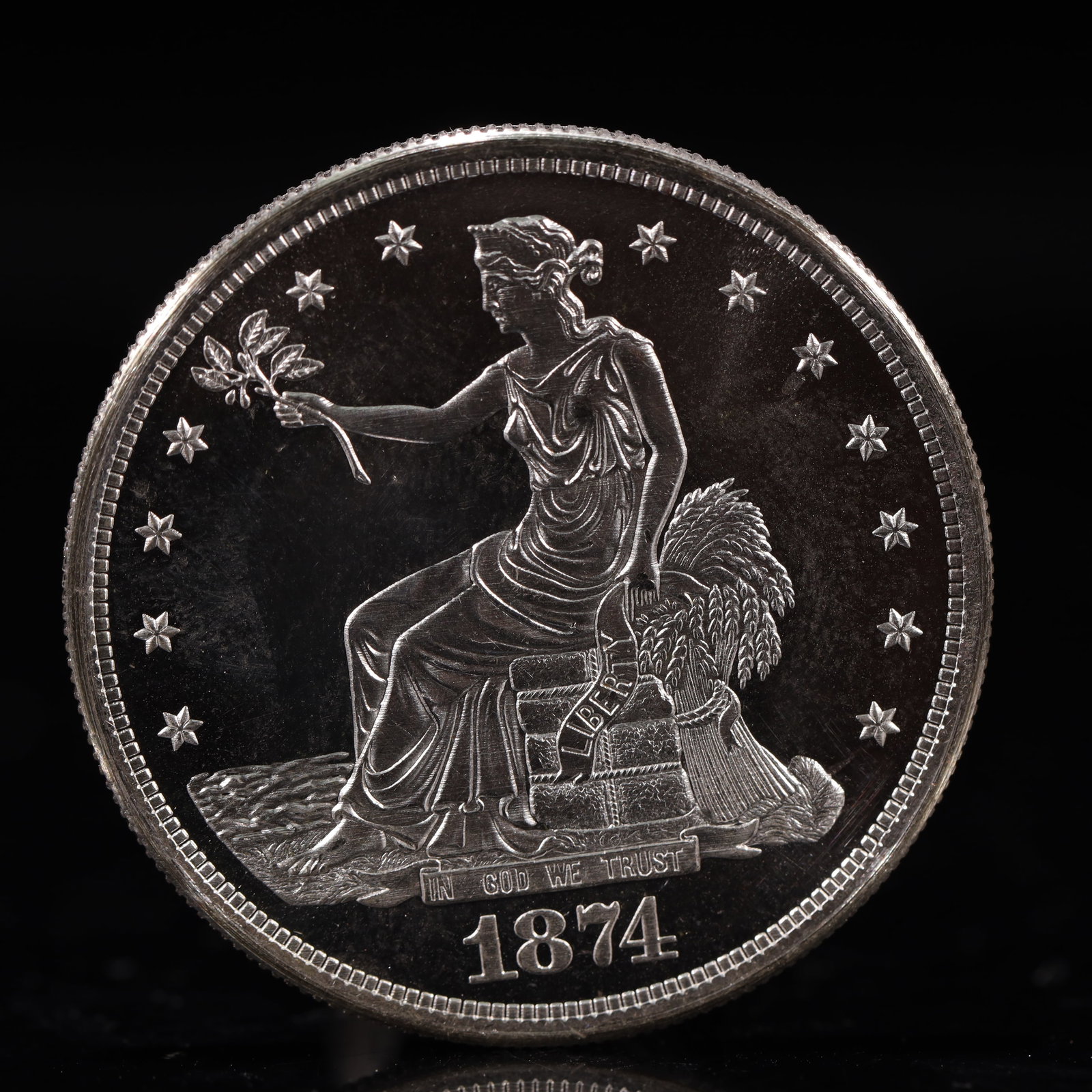 USA Trade Dollar 1874 Coin: American coin. Obverse: Liberty seated on a pedestal facing the sea to the left holding olive branches surrounded by 13 stars. IN GOD WE TRUST / LIBERTY / 1874. Reverse: An eagle holding branches with