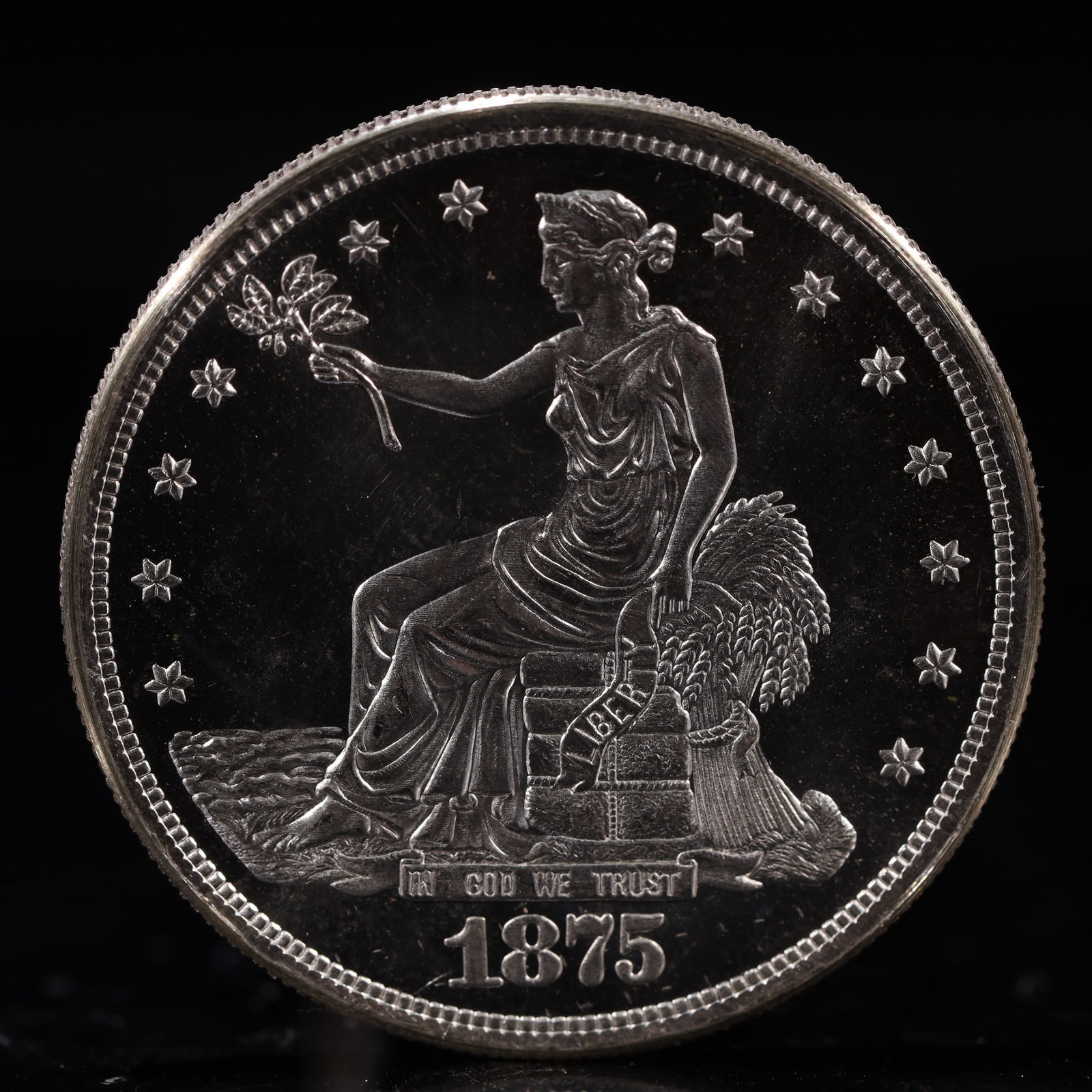 USA Trade Dollar 1875 Coin: American coin. Obverse: Liberty seated on a pedestal facing the sea to the left holding olive branches surrounded by 13 stars. IN GOD WE TRUST / LIBERTY / 1875. Reverse: An eagle holding branches with