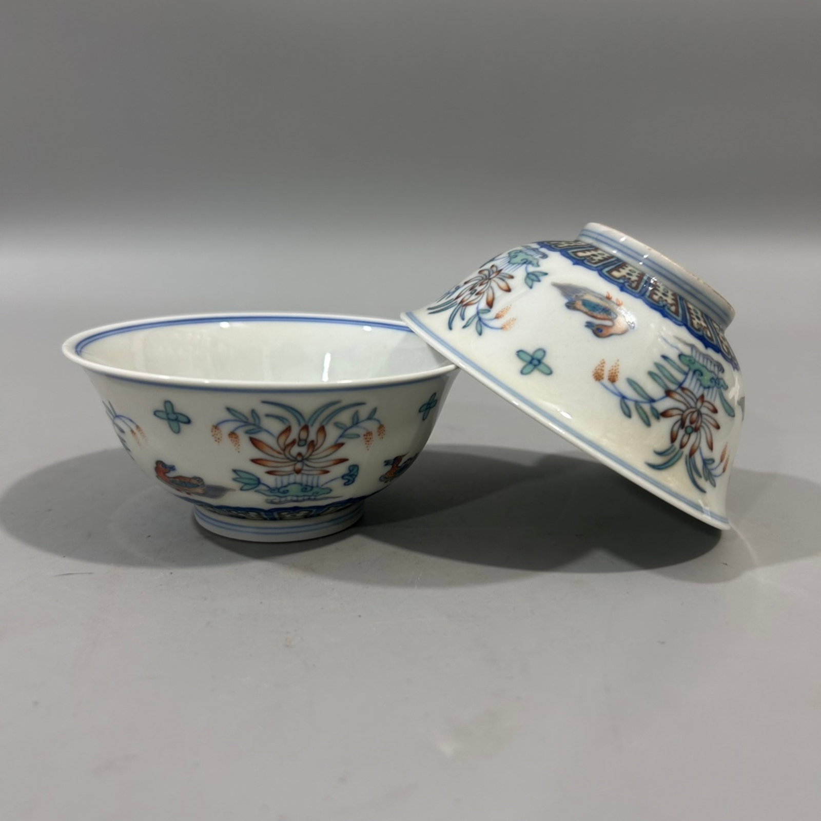 A Pair of Exquisite Doucai Lotus and Mandarin Duck Pattern Cups: A Pair of Exquisite Doucai Lotus and Mandarin Duck Pattern Cups,Qing Dynasty,China,Yongzheng Six-character Mark,Size:3.9inx1.8in
