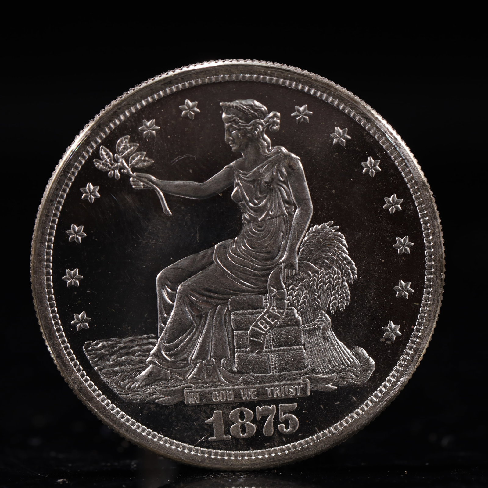 USA Trade Dollar 1875 Coin: American coin. Obverse: Liberty seated on a pedestal facing the sea to the left holding olive branches surrounded by 13 stars. IN GOD WE TRUST / LIBERTY / 1875. Reverse: An eagle holding branches with