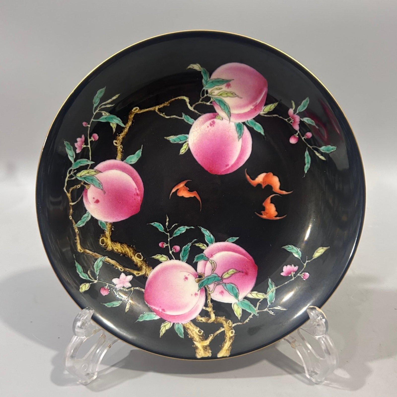 An Exquisite Ji Red Glazed Black Ground Famille-Rose Bats and Peach Pattern Plate: An Exquisite Ji Red Glazed Black Ground Famille-Rose Bats and Peach Pattern Plate,Qing Dynasty,China,Qianlong Four-character Mark,Size:6.9inx1.6in 霁红釉黑地粉ô