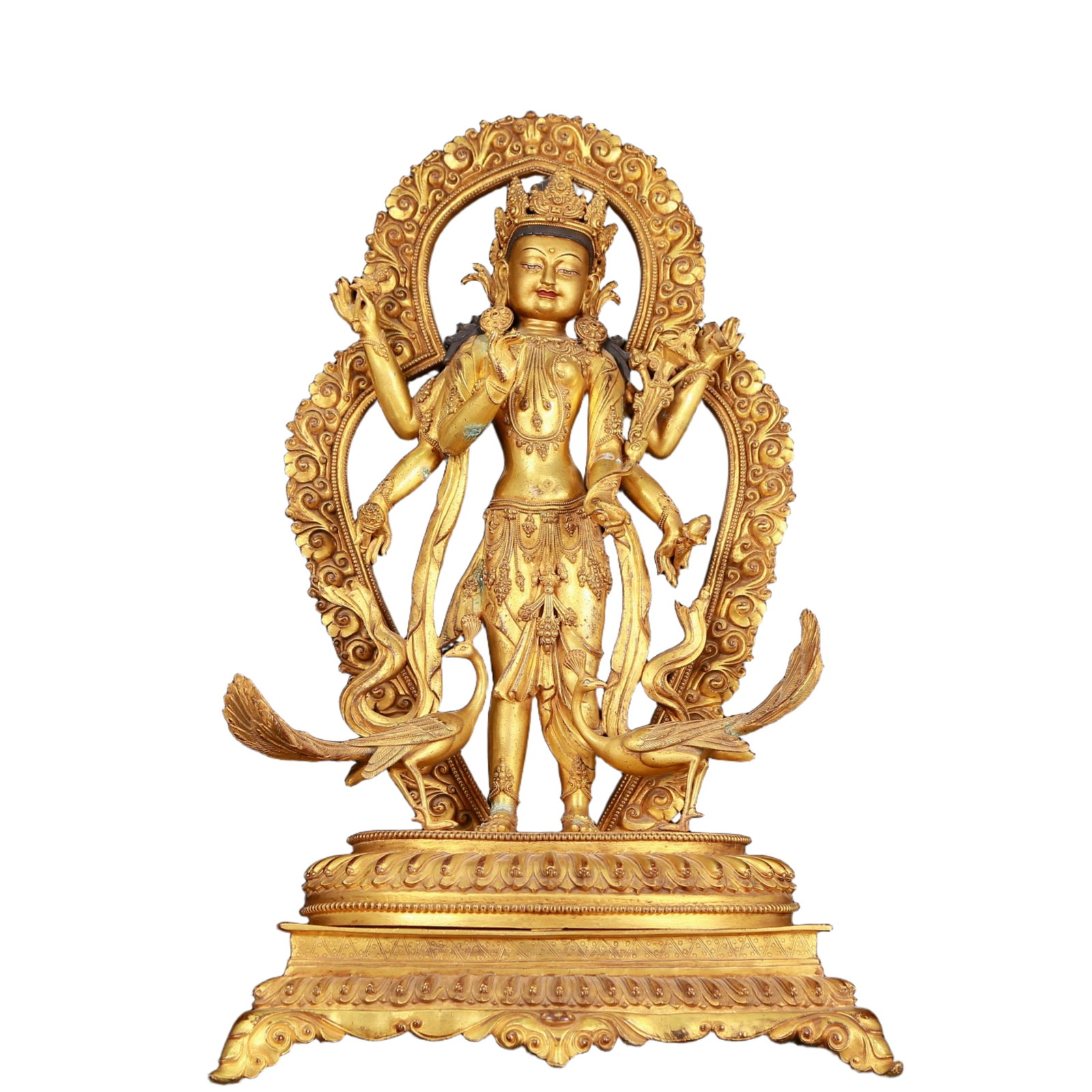A huge gilt bronze statue of Manjushri with six arms: huge gilt bronze six-armed statue of Manjushri Bodhisattva, Ming Dynasty, China. Manjushri Bodhisattva wears a gorgeous crown on his head. The crown is dotted with gems, making it look more mysterious