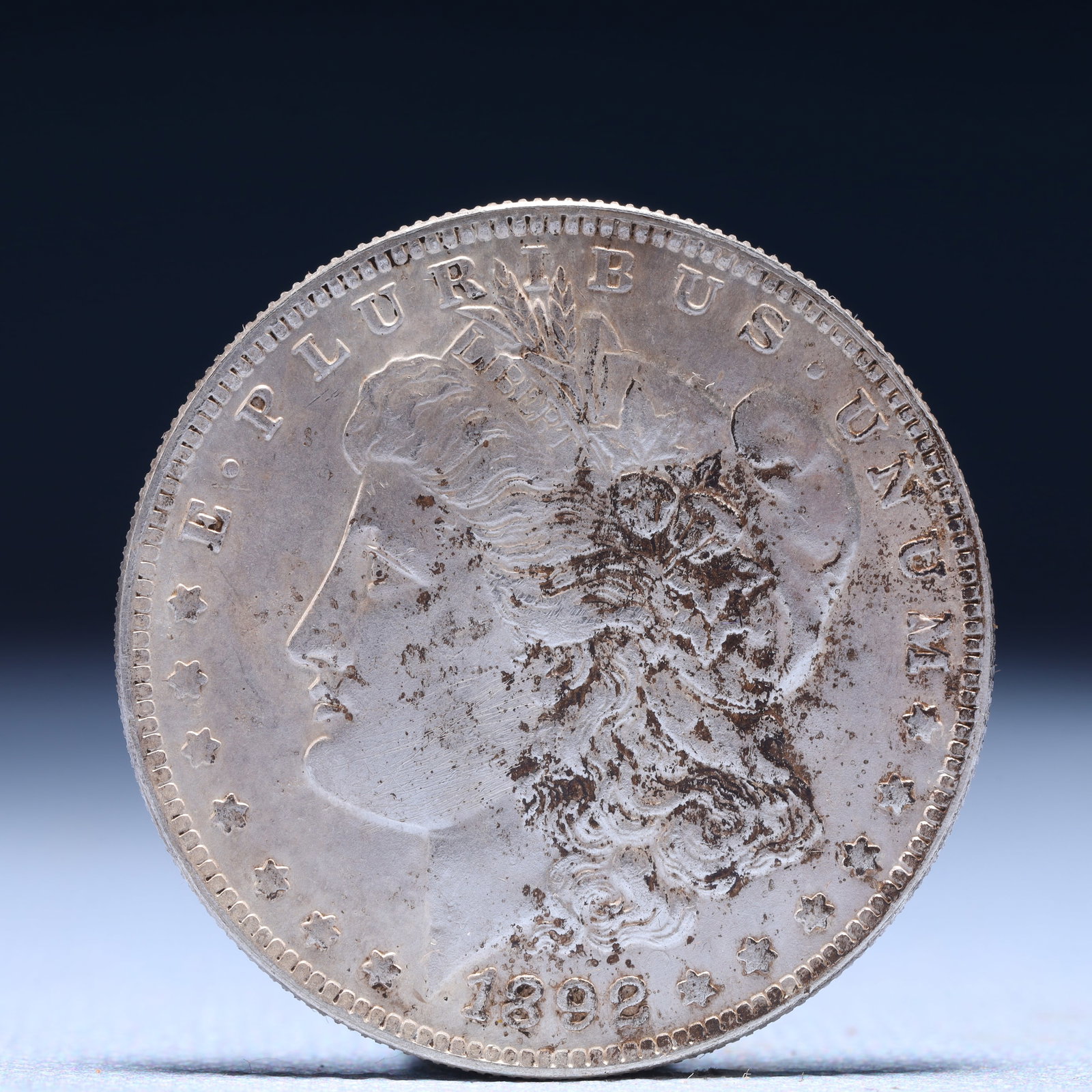USA Morgan Dollar 1892 Coin: Obv: profile bust with date below and E PLURIBUS UNUM legend and stars around. Rev: eagle with In God we trust above within wreath with UNITED STATES OF AMERICA ONE DOLLAR legend. IN GOD WE TRUST / LI