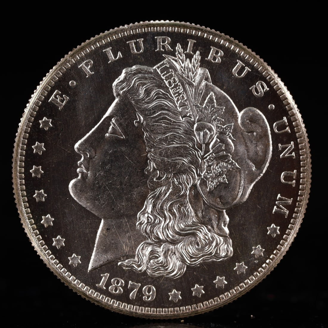 USA Morgan Dollar 1879 Coin: Obv: profile bust with date below and E PLURIBUS UNUM legend and stars around. Rev: eagle with In God we trust above within wreath with UNITED STATES OF AMERICA ONE DOLLAR legend. IN GOD WE TRUST / LI