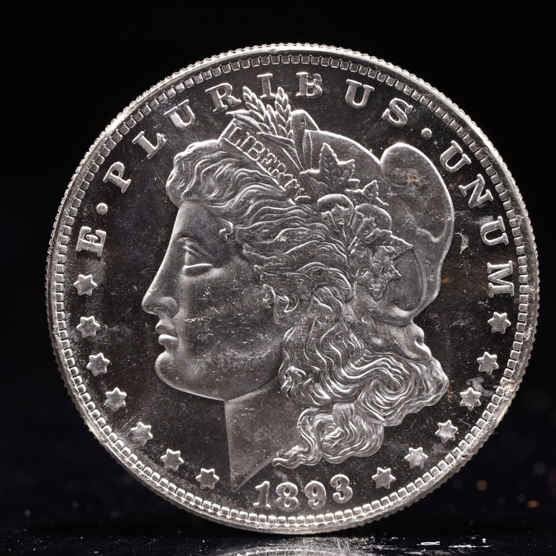 USA Morgan Dollar 1893 Coin: Obv: profile bust with date below and E PLURIBUS UNUM legend and stars around. Rev: eagle with In God we trust above within wreath with UNITED STATES OF AMERICA ONE DOLLAR legend. IN GOD WE TRUST / LI