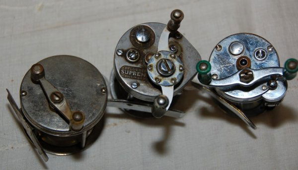 Pflueger Supreme, Pflueger Akron (No. 1893), and ano: Pflueger Supreme, Pflueger Akron (No. 1893), and another older reel.