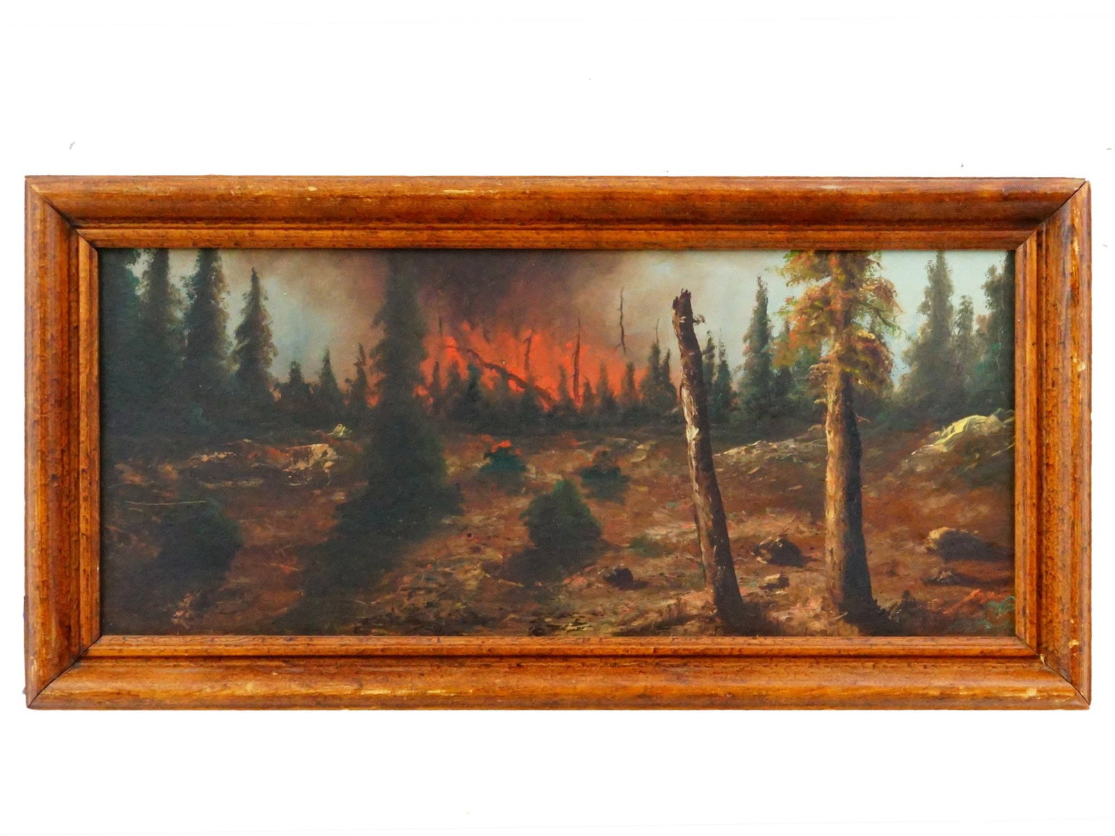 ANTIQUE AMERICAN WILDFIRE LANDSCAPE OIL PAINTING: Oil painting on board. American school, dated late 19th to early 20th century. The artwork depicts a coniferous forest set on fire. Unsigned. Framed. Keywords: Landscape, Collectibles, Fine Art, Paint