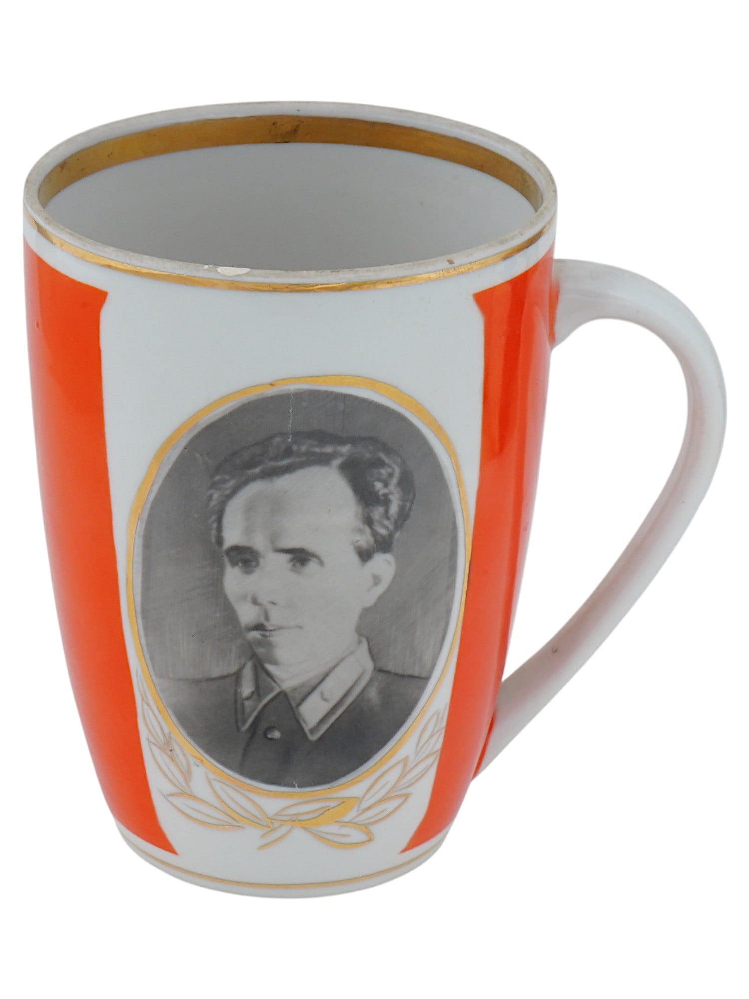 UKRANIAN SOVIET ERA PORCELAIN CUP NIKOLAI OSTROVSKY: A Ukranian Soviet era hand-painted porcelain cup. Ca. 1960s, Polonsky Art Ceramics Factory. The piece represents a portrait of Nikolai Ostrovsky (1904–1936), a Soviet socialist realist writer known