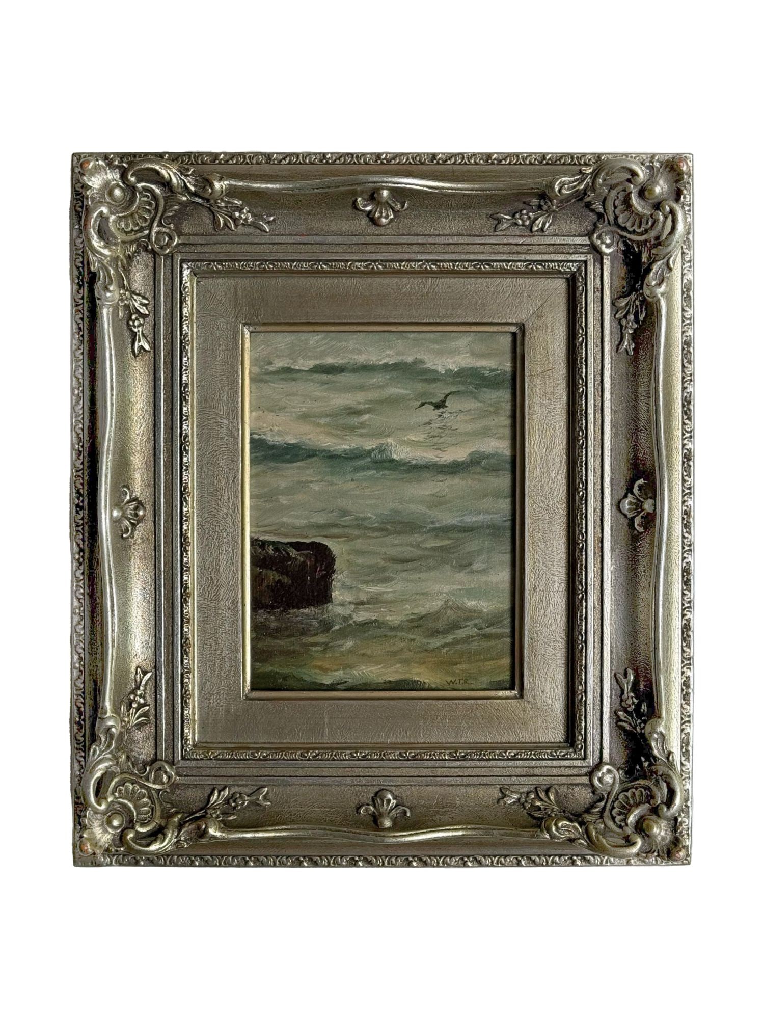 ATTRIBUTED WILLIAM TROST RICHARDS COASTAL LANDSCAPE PAINTING: Attributed to American landscape artist William Trost Richards, this oil on board painting depicts a dynamic coastal seascape with churning green waves crashing against a dark rocky outcropping under 