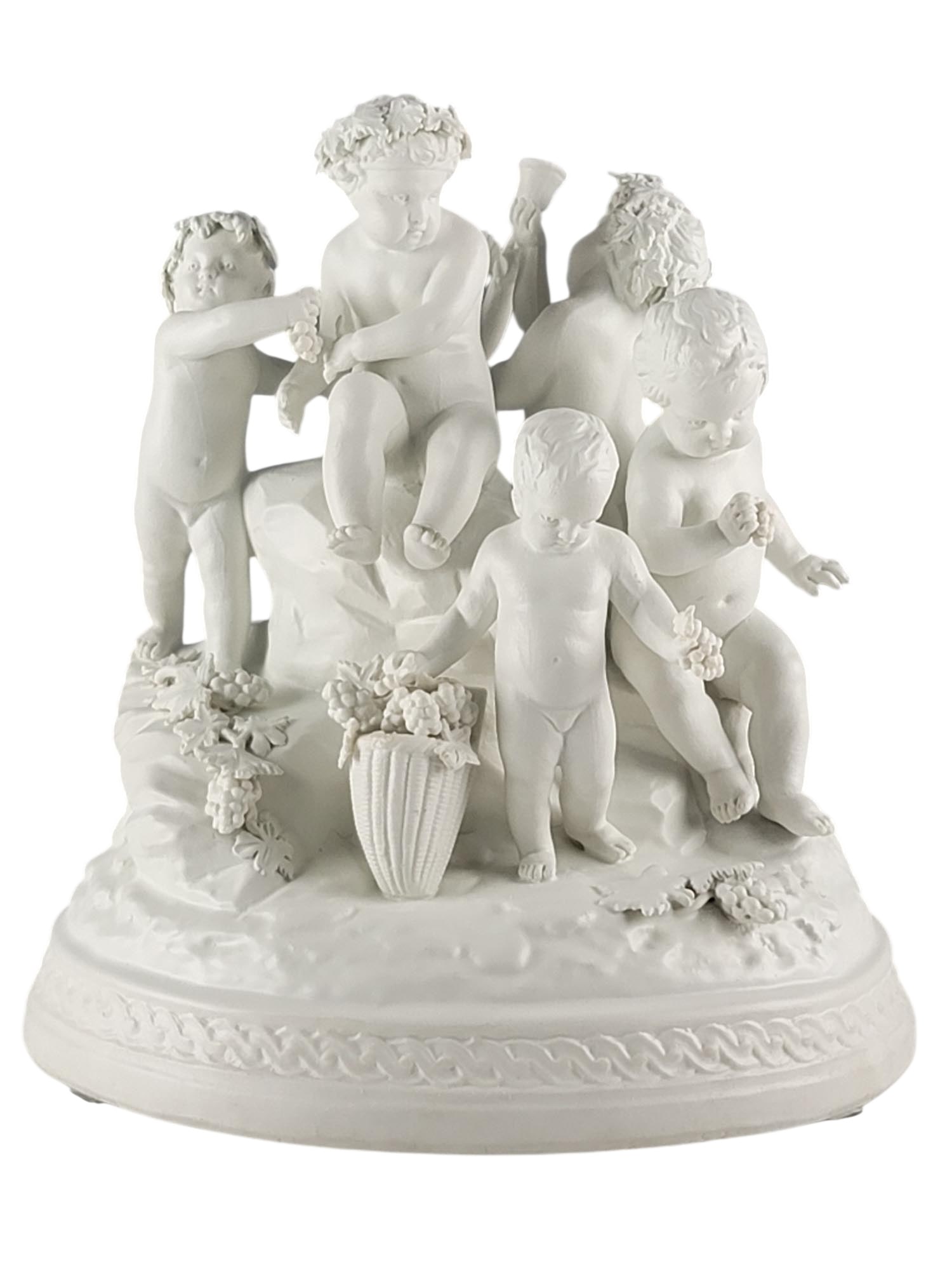19TH CENTURY SEVRES BISQUE PORCELAIN PUTTI SCULPTURE: This fine 19th-century French Sevres bisque (biscuit) porcelain sculpture depicts a Bacchanalian group of putti with grapes, inspired by the designs of Francois Boucher. The unglazed white porcelain e