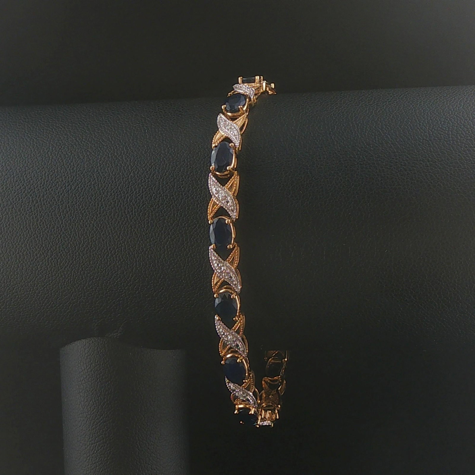 14k Yellow and White Gold Sapphire and Diamond Fancy X Link Bracelet 7.25": Condition: Excellent Condition, Professionally Cleaned Metal: 14k Gold (Marked, and Professionally Tested) Weight: 9g Gemstones: Oval Cut Blue Sapphires Diamonds: 0.14cttw Round Cut Small Natural Diam