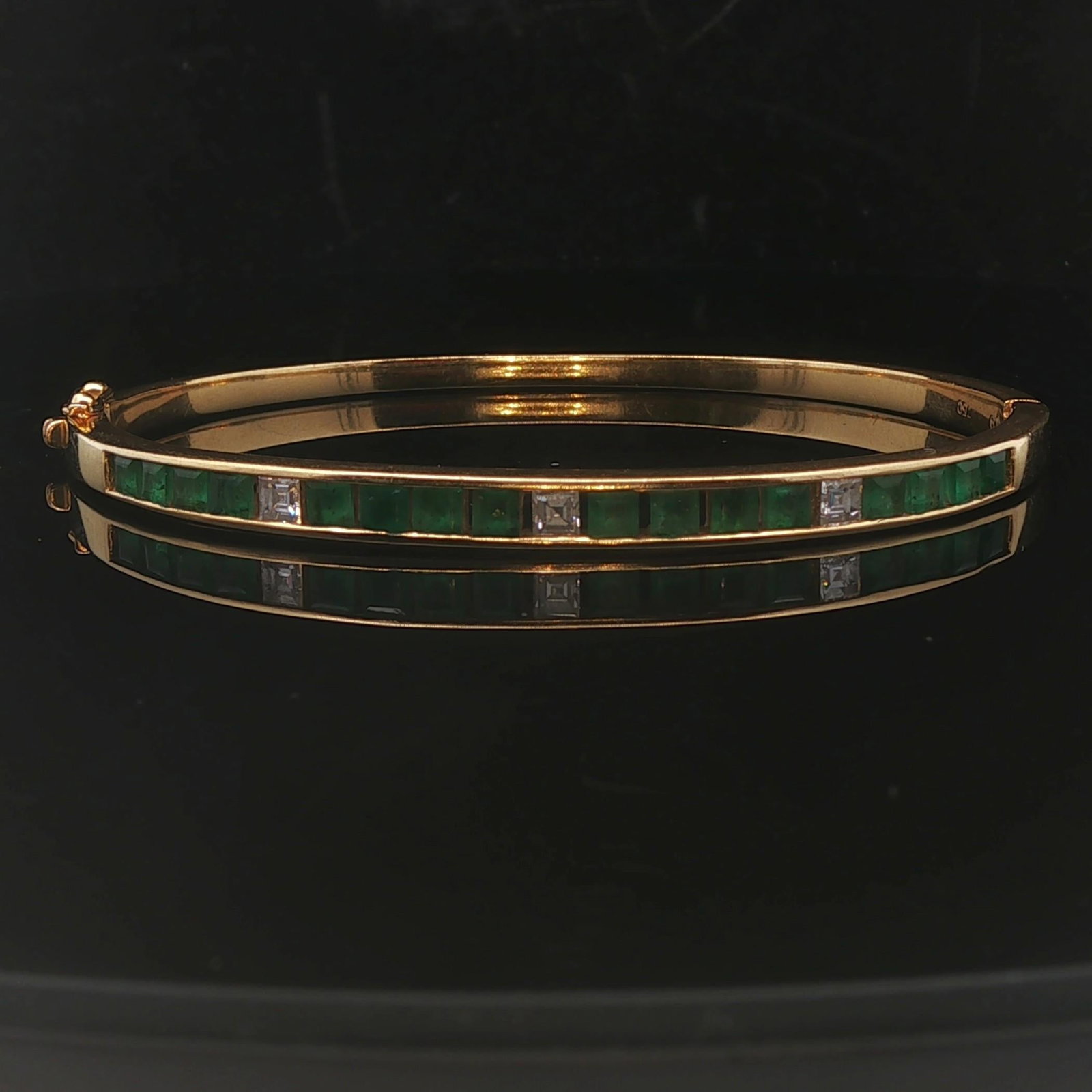 18k Yellow Gold Emerald and Diamond Solid Bangle: Condition: Excellent Condition, Professionally Cleaned Metal: 18k Gold (Marked, and Professionally Tested) Weight: 18.3g Gemstones: 1.6cttw Princess Cut Emeralds Diamonds: Three Princess Cut Natural D
