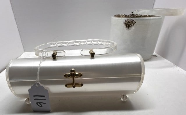 VINTAGE LUCITE ACRYLIC BOX PURSES: TWO VINTAGE LUCITE ACRYLIC BOX PURSES, ONE CRESCENT SHAPED PURSE WITH ORNAMENTAL DECORATION ON LID, ONE VINTAGE CYLINDAR SHAPED PURSE BY CHARLES S. KAHN FROM SAKS FIFTH AVENUE