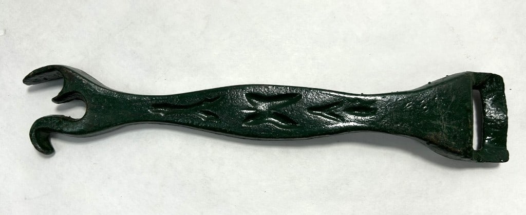 VINTAGE CAST IRON STOVE OPENER: PAINTED GREEN IN COLOR