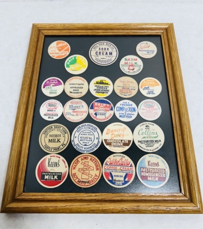 VINTAGE MILK BOTTLE CAPS DISPLAYED IN WOODEN FRAME: .