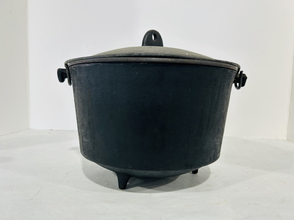 FOOTED CAST IRON POT: .