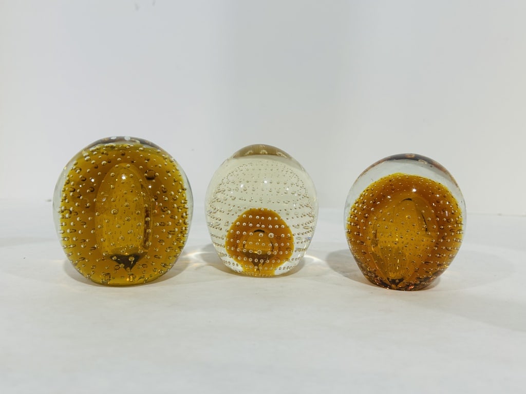 VINTAGE AMBER PAPER WEIGHTS: .