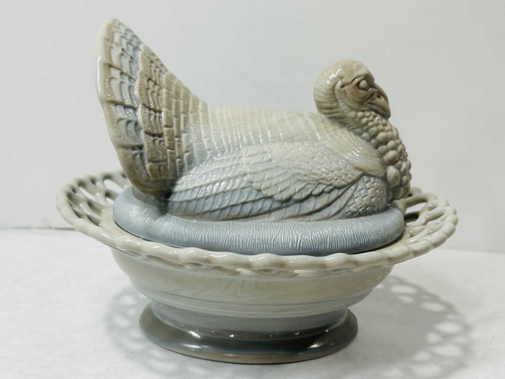 Mosser Marble Turkey on Nest: The turkey-form lid is detailed with a fanned tail and textured plumage, sitting atop a tall pedestal base with a reticulated lattice-work rim. An embossed "Mâ€? mark is located on the interior.