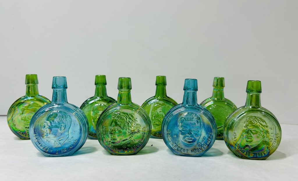 Eight Wheaton Glass Miniature Presidential Commemorative Carnival Glass Bottles: This collection consists of eight miniature commemorative flasks produced by the Wheaton Glass Company of Millville, New Jersey, under their Nuline division. The bottles are manufactured from iridesce