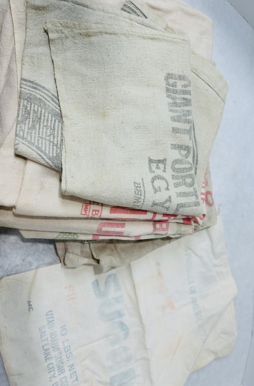 Vintage Printed Cloth Advertising Sacks: This lot consists of an assortment of vintage printed cloth advertising sacks, originally used for the transport and storage of various agricultural and industrial commodities. The collection includes