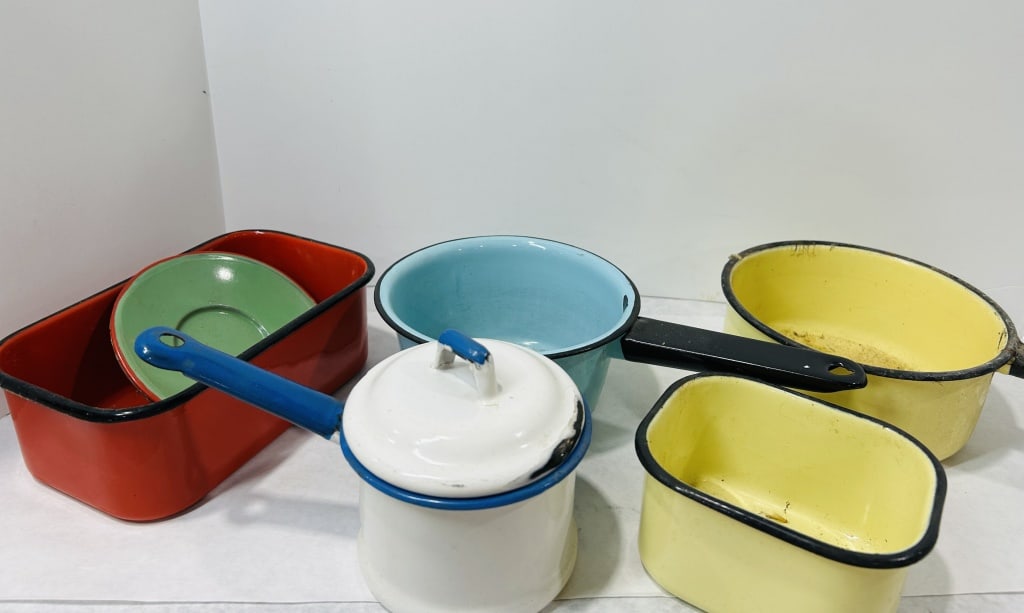 Vintage Mid-Century Colorful Enamelware Kitchen Items: This collection consists of six vintage enamelware kitchen items dating to the mid-20th century. The group includes a large rectangular red baking or roasting pan with a black rim, a small green sauce