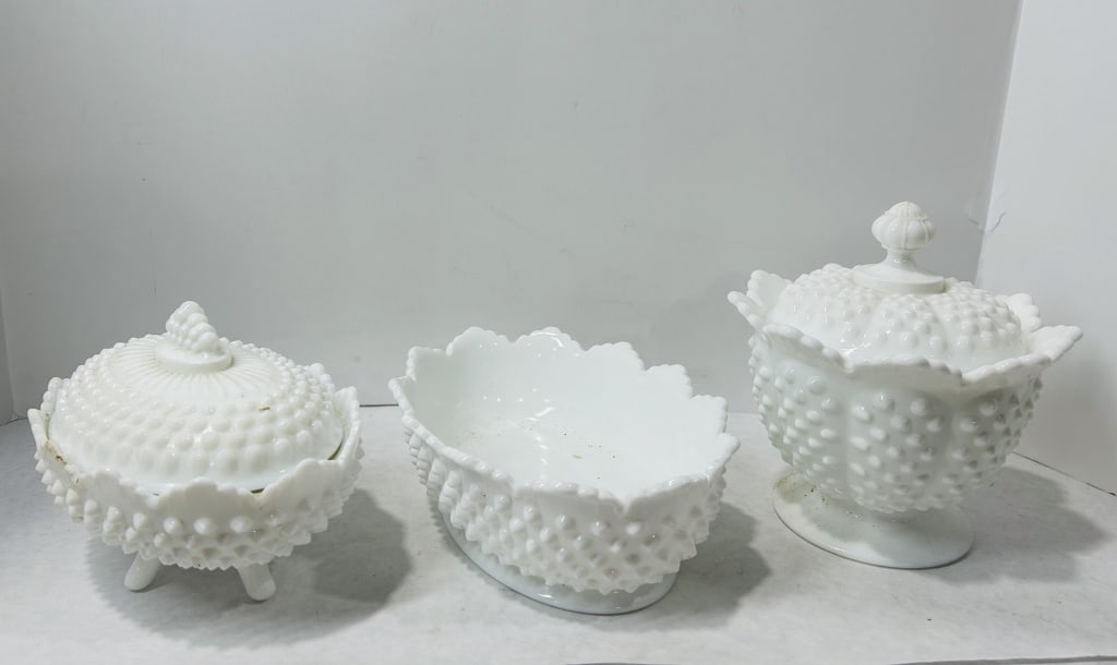 3 Fenton Hobnail White Milk Glass Tableware: This collection consists of three white milk glass items manufactured by the Fenton Art Glass Company in the hobnail pattern. The group includes a pedestal footed lidded candy dish, a three-footed lid