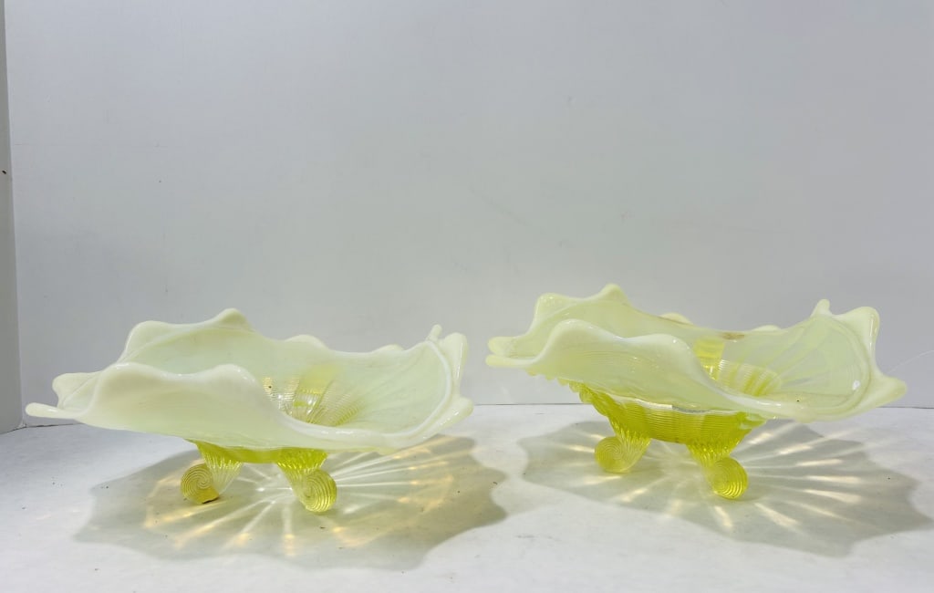 Victorian Uranium and Opalescent Glass Footed Bowls: This pair of footed bowls is attributed to Northwood and features the Fluted Scrolls pattern. The bowls are crafted from yellow uranium or vaseline glass, characterized by an opalescent treatment at t