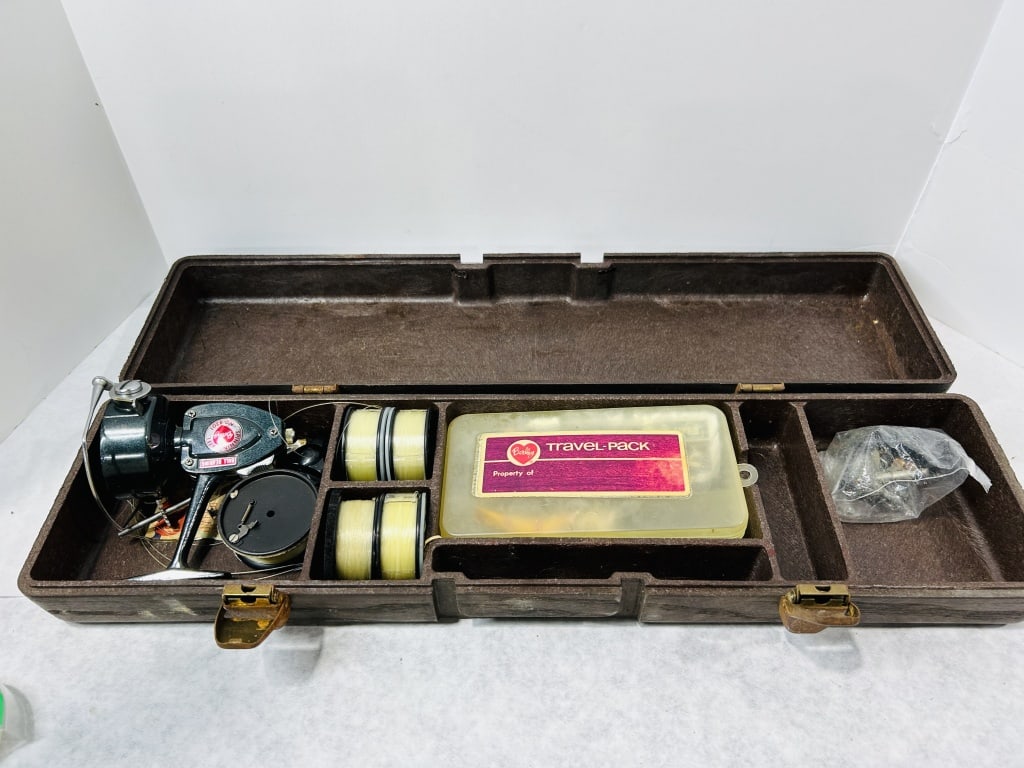 A Vintage Berkley No. 4201 Spinning Reel and Partial Travel-Pack Fishing Kit: This vintage Berkley fishing set is contained within a brown textured plastic carrying case featuring a molded interior. The kit includes a Berkley No. 4201 spinning reel, which is identified by a red