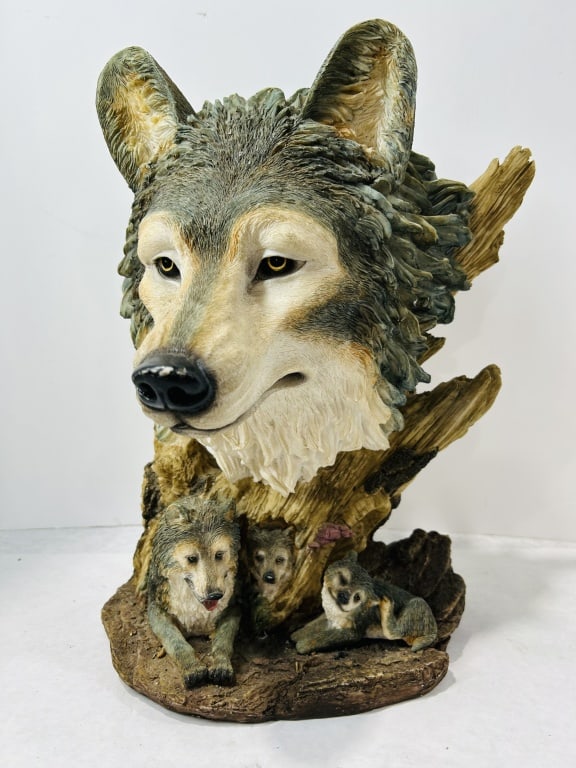 Cast Resin Wolf Bust Sculpture Attributed to Stephen Herrero: This cast resin wildlife sculpture features a central wolf head bust integrated into a base modeled after weathered driftwood. Three smaller wolves are situated at the base, including a reclining juve