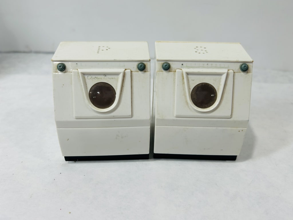 A Pair of Westinghouse Plastic Washer and Dryer Salt and Pepper Shakers: A pair of mid-century modern novelty salt and pepper shakers produced as sales promotion items, designed in the form of miniature Westinghouse laundry appliances. The set consists of a front-loading w