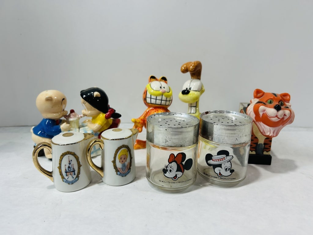 Vintage Character-Themed Salt and Pepper Shakers and Disneyland Souvenirs: A collection of vintage character-themed collectibles and souvenir items. The group includes ceramic salt and pepper shakers modeled as Porky Pig and Petunia Pig seated at a soda fountain counter. Als